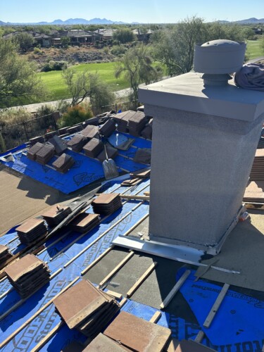 On the roof of a new project, underlayment is being installed before the tiles are placed.